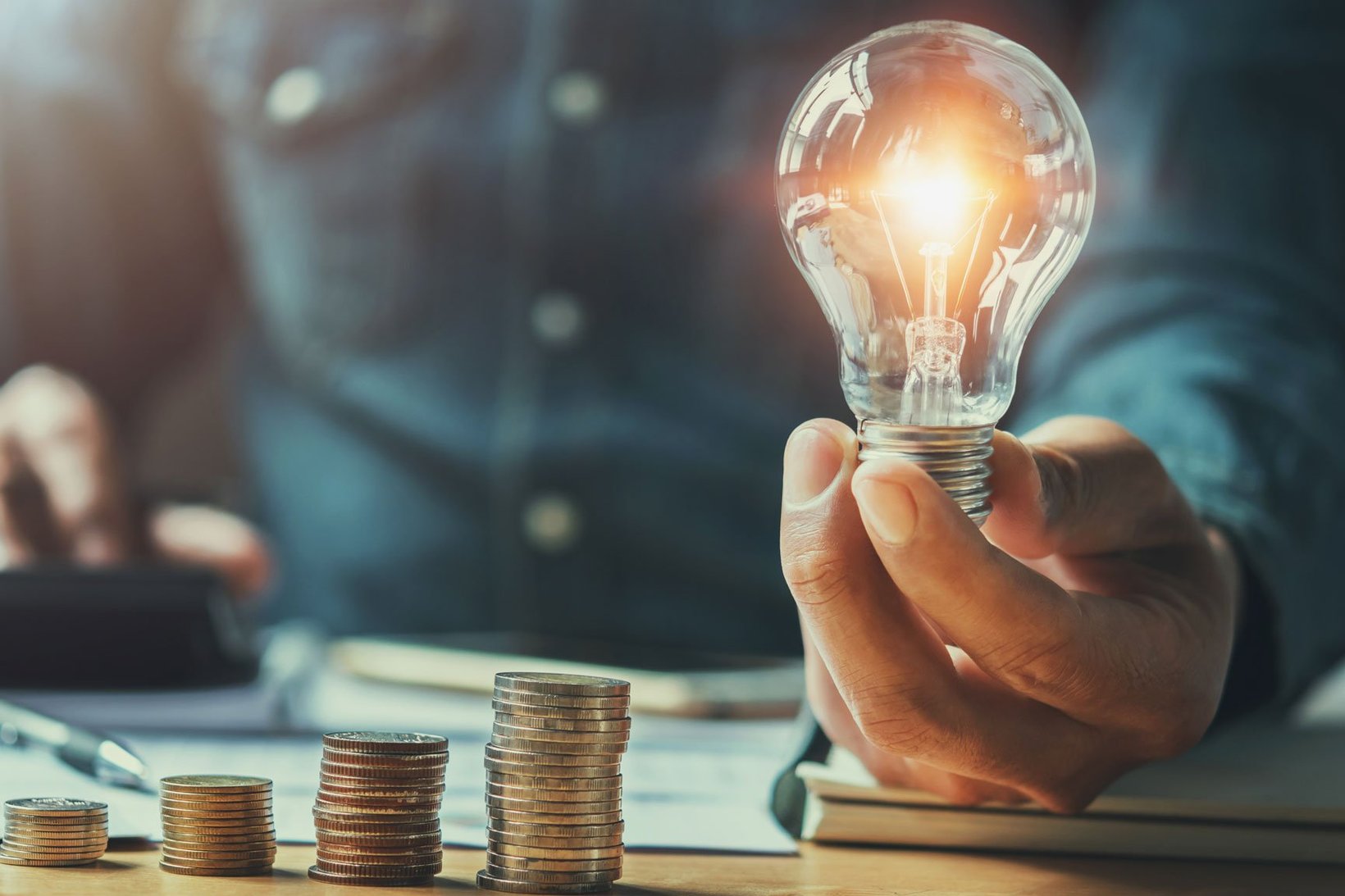Man with lightbulb in hand. Photo: Adobe Stock