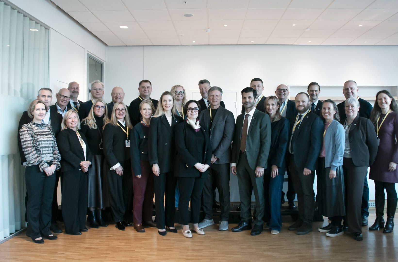 Group of participants gathered for a photo in an office following a meeting.