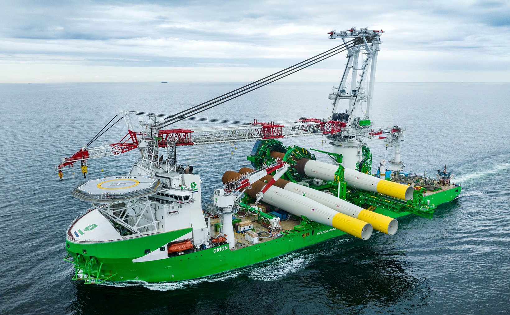 Large DEME offshore installation vessel carrying wind turbine foundations.