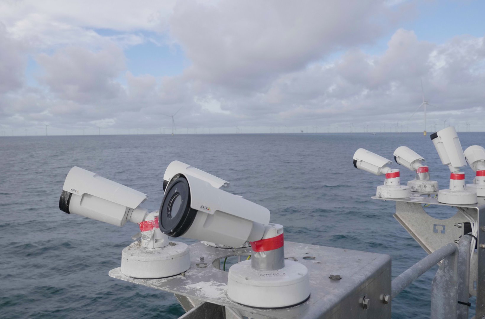 Cameras mounted on a platform overlooking the sea.