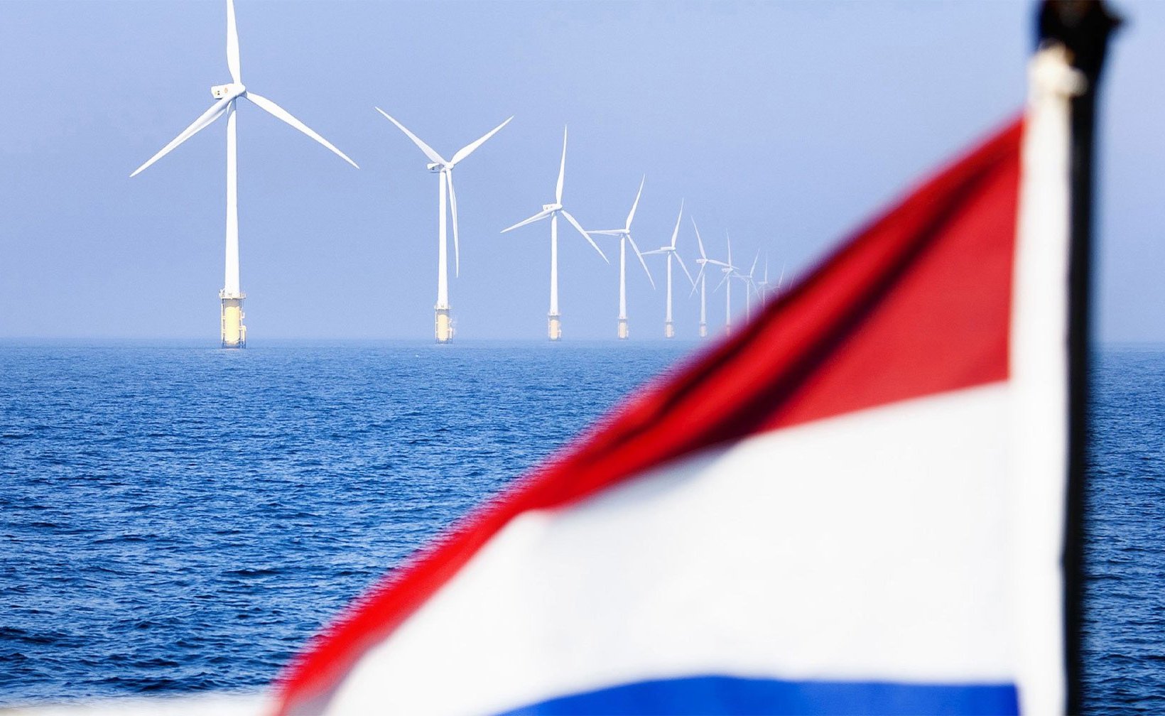 Hollandse Kust wind farm, with a Dutch flag in the foreground