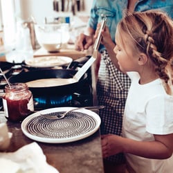 Young girl looks into a pot