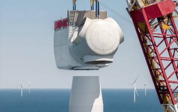 A large crane lifting the nacelle into place on a wind turbine at Hollandse Kust Zuid offshore wind farm. A large crane lifting the nacelle into place on a wind turbine at Hollandse Kust Zuid offshore wind farm.