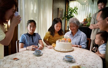 Family sitting at dinner table 