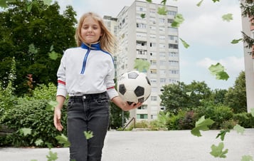 A girl with a football in her hand