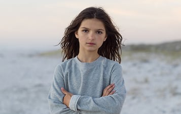 Girl on beach looking into camera