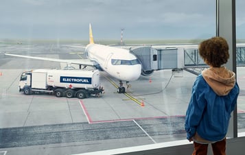  A child watching an airoplane at an airport