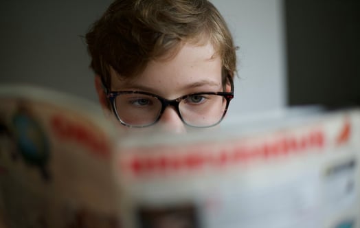 Boy reading a newspaper