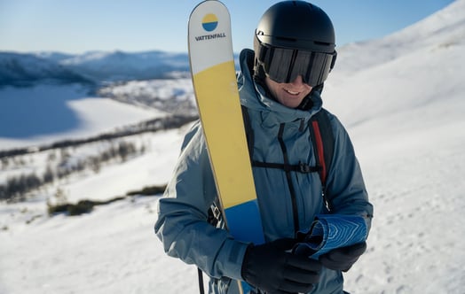  A skier holding a pair of Evi skis made with parts from a decommissioned wind turbine