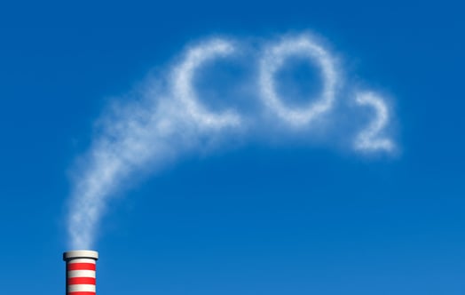 Smoke from a chimney forming the word CO2