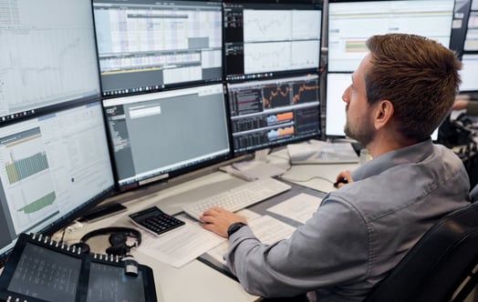A man in front of computer screens in Vattenfall's trading office in Hamburg