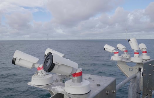 Cameras mounted on a platform overlooking the sea.