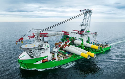 Large DEME offshore installation vessel carrying wind turbine foundations. Large DEME offshore installation vessel carrying wind turbine foundations.