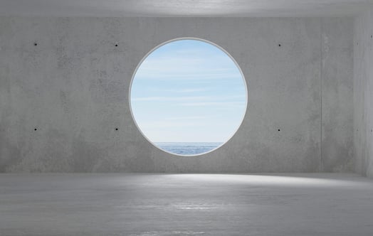 Concrete room with a circular window