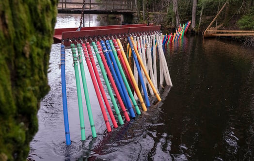 Colorful plastic rods suspended in a row. Photo: Johan Gunséu.