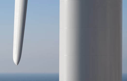 Close-up of the tower and a blade of an offshore wind turbine