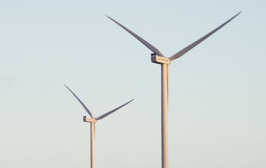 Two wind turbines against a blue sky