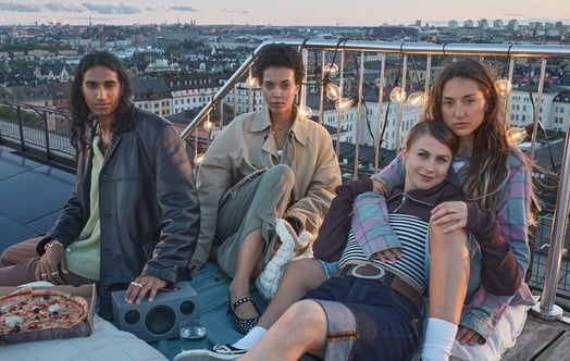 Four young people having a picnic on a roof