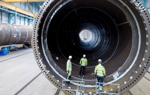 Three workers inside a wind turbine component for Hollandse Kust Zuid