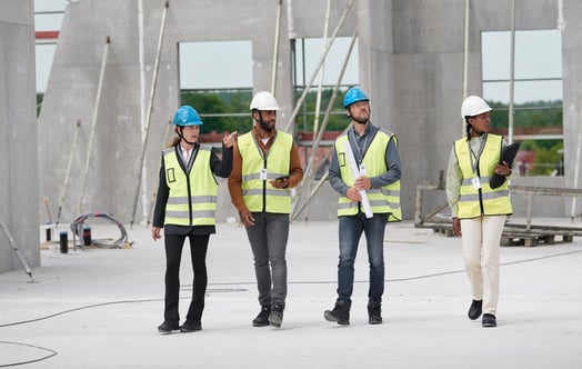 Four people on a construction site