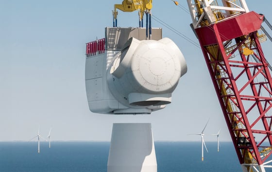 A large crane lifting the nacelle into place on a wind turbine at Hollandse Kust Zuid offshore wind farm. A large crane lifting the nacelle into place on a wind turbine at Hollandse Kust Zuid offshore wind farm.