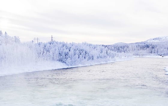 Winter landscape in nothern Sweden with power line.