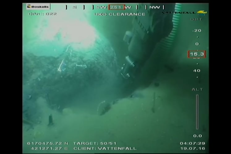 Naval mine hidden in the seabed sand