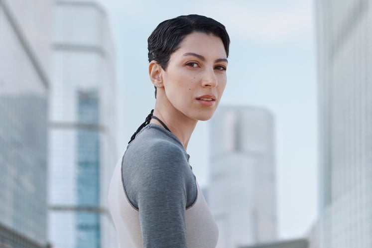 Woman with short dark hair looking into the camera, with city skyscrapers in the background. Woman with short dark hair looking into the camera, with city skyscrapers in the background.