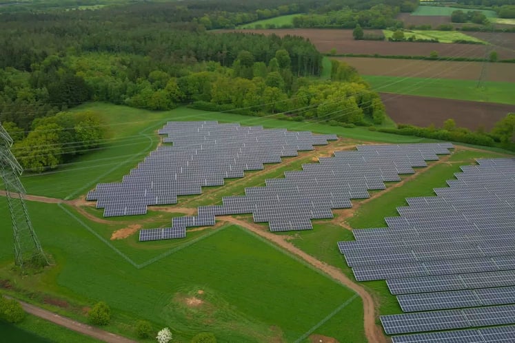 Aerial view of the nearly completed solar park set against a green landscape.
