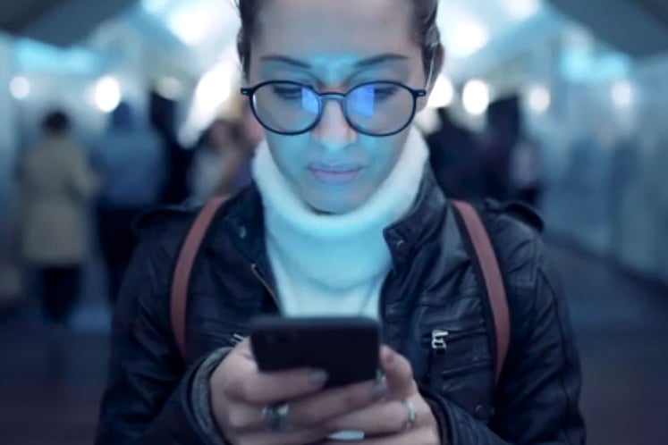 Woman looks at her mobile phone