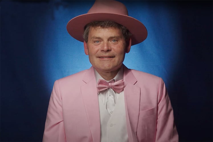 Man wearing a pink jacket and hat