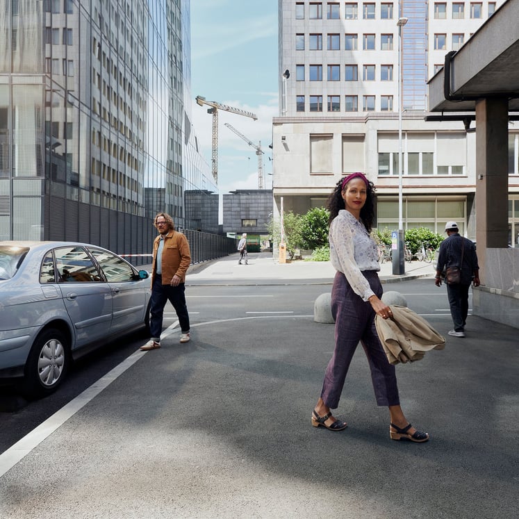 People and a car in an urban landscape