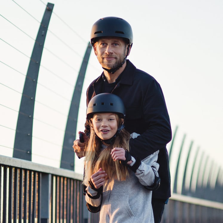 A man and a girl wearing helmets