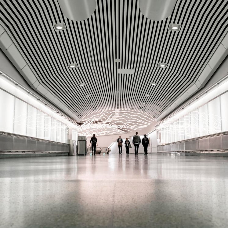 People in a walkway in the Stockholm metro system.