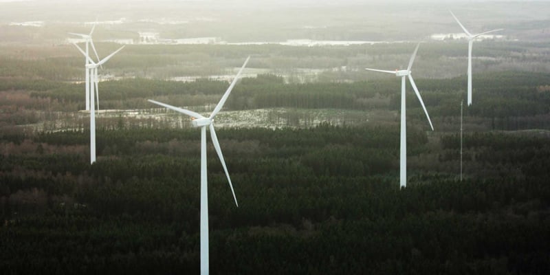 Wind turbines in a forest landscape. Wind turbines in a forest landscape.