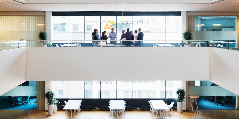 A group of people gathered in a light and airy atrium inside Vattenfall's head office. A group of people gathered in a light and airy atrium inside Vattenfall's head office.