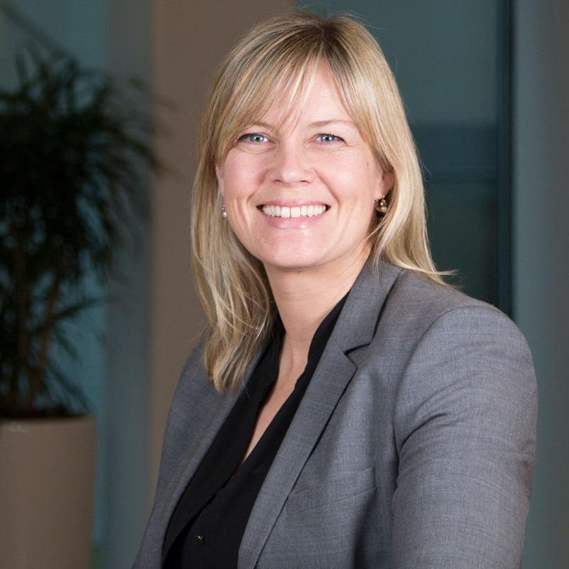 Helle Herk-Hansen, Head of Environment, seated indoors in an office environment.