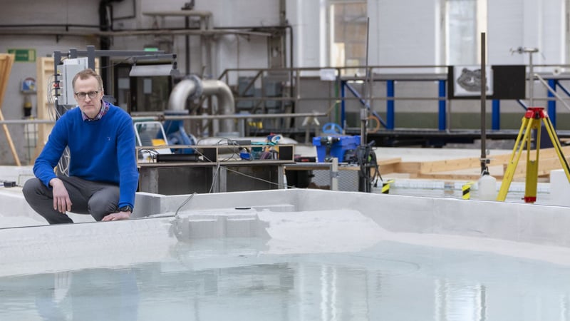 Man in a blue shirt sitting in front of a pool in the R&D centre in Älvkarleby.