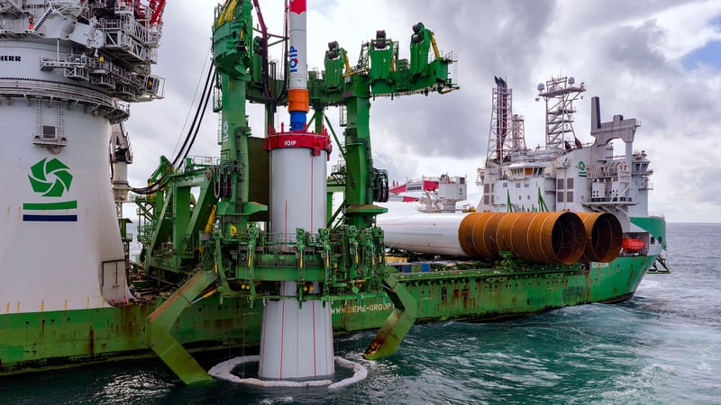 Vessel installing wind turbine foundations at sea. Vessel installing wind turbine foundations at sea.