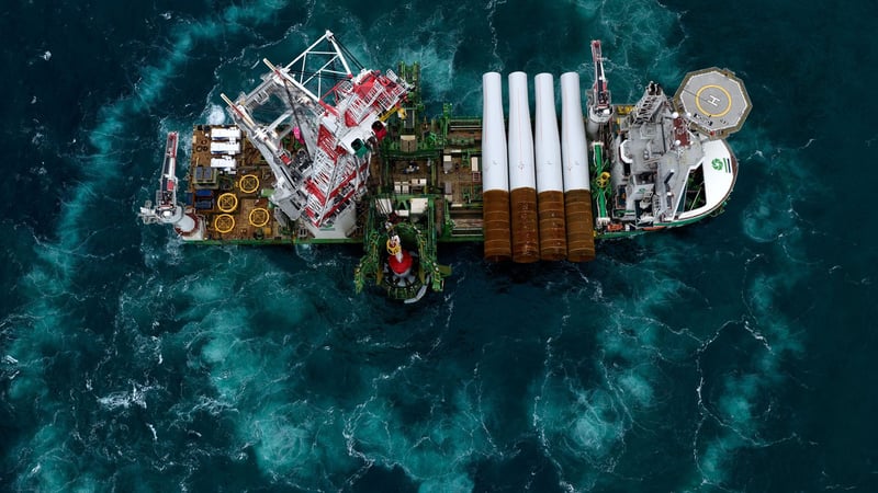 Aerial view of an offshore vessel carrying large wind turbine components.
