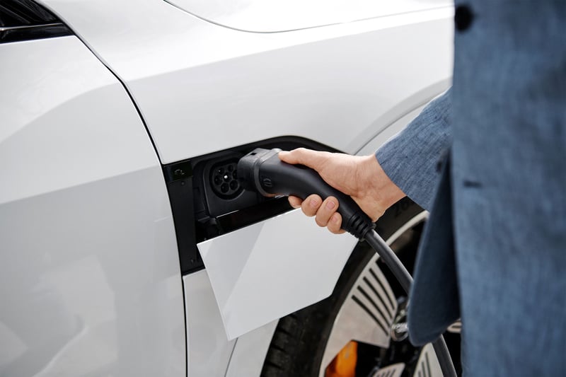 Man charging electric car