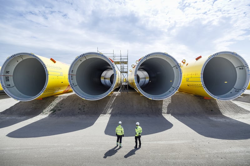 Men looking at wind turbine components