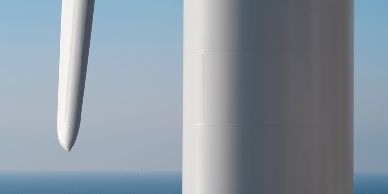 Close-up of the tower and a blade of an offshore wind turbine Close-up of the tower and a blade of an offshore wind turbine