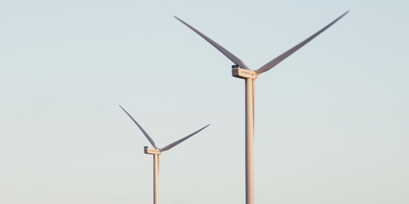 Two wind turbines against a blue sky Two wind turbines against a blue sky