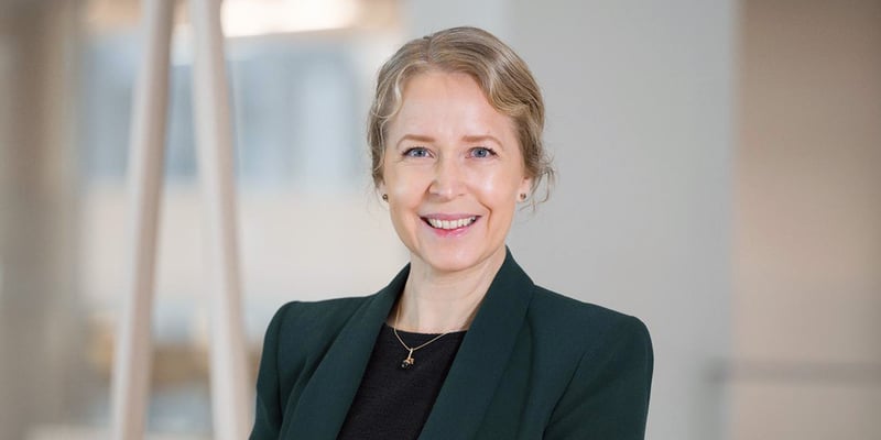 Lovisa Fricot Norén, Head of Hydro Nordic, wearing a dark blazer and top, posing indoors against a softly lit, neutral background.