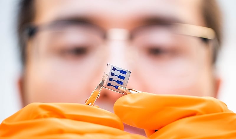 Men looking at a solar cell