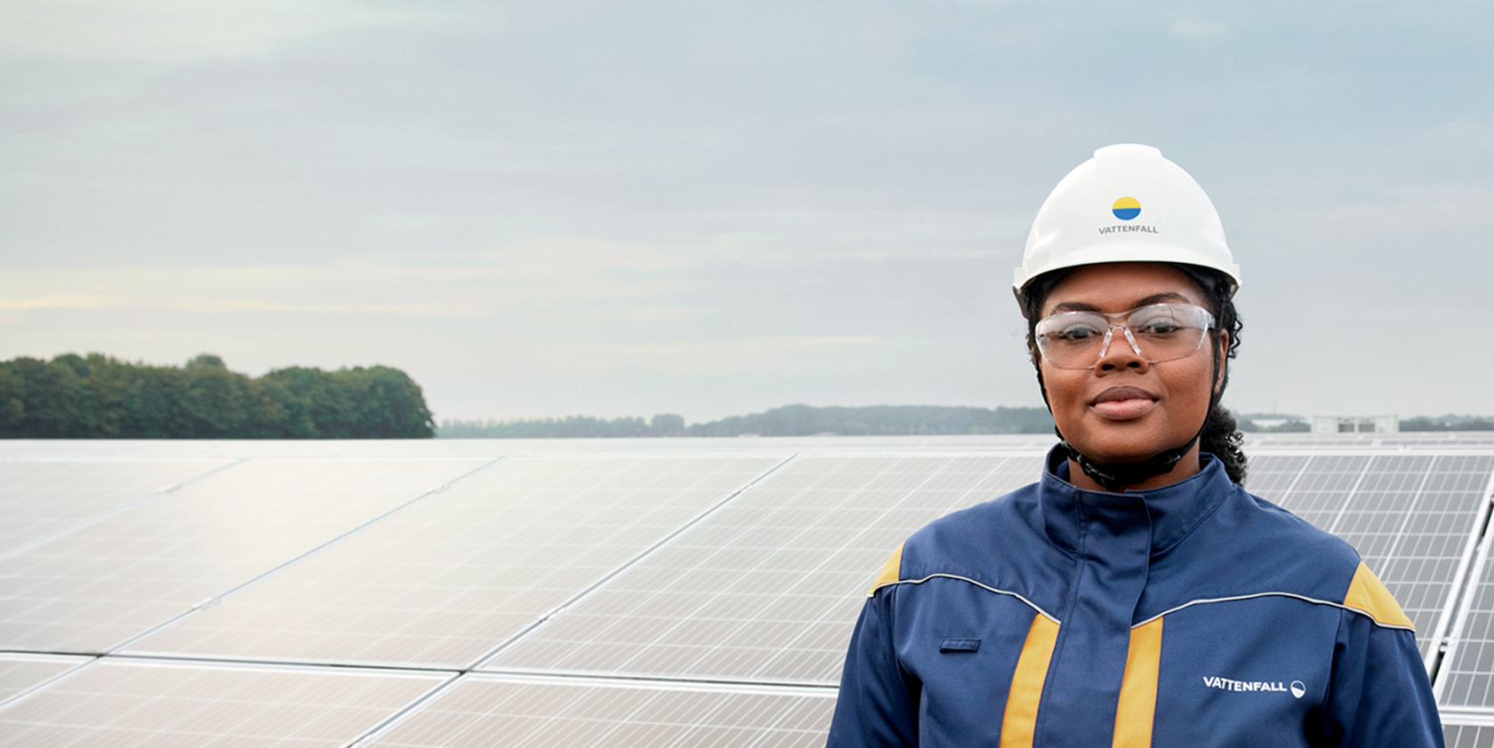 A female blue collar worker in hardhat in combined energy park
