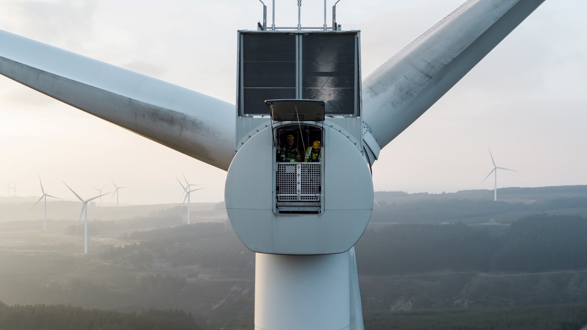 Technicians inside a wind turbine nacelle