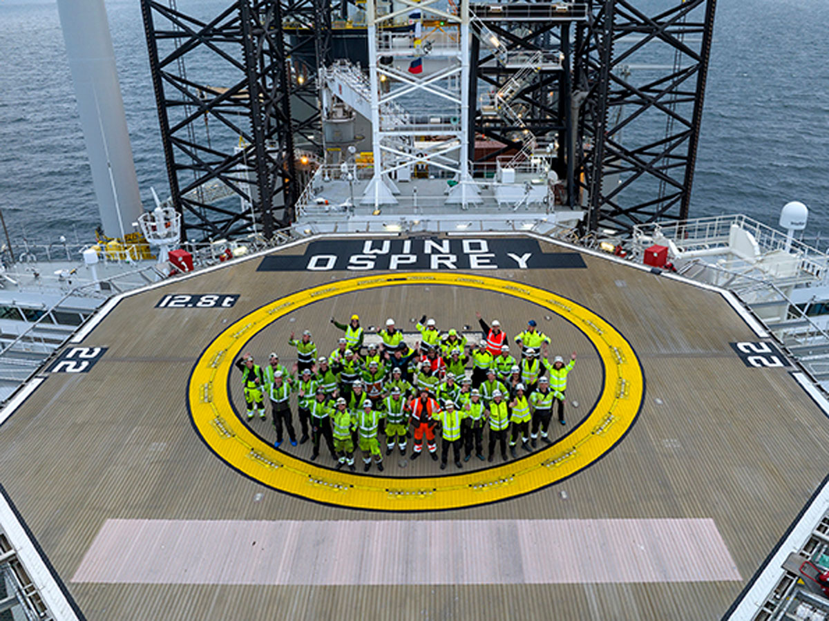 The crew on the helideck celebrate the installation of the latest turbine. Photo: Matthias Ibeler