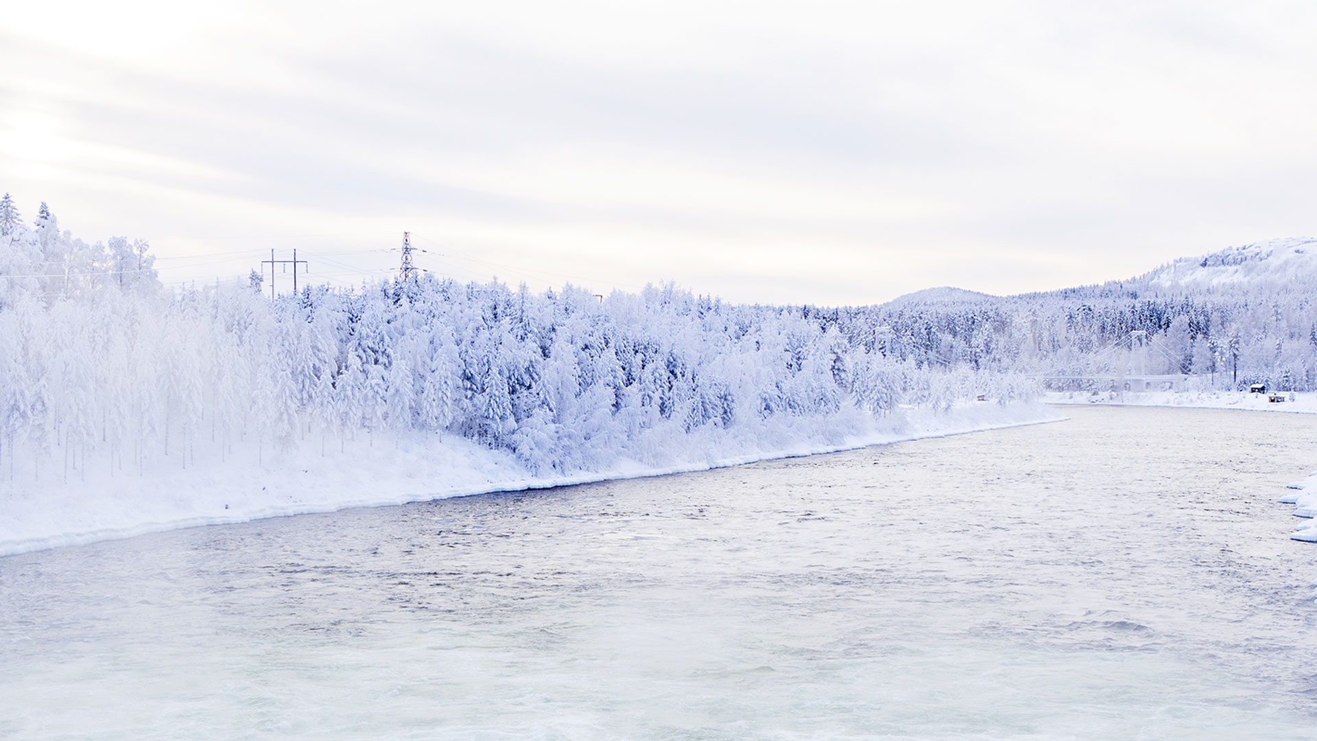 Winter landscape in nothern Sweden with power line.